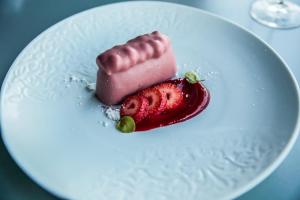 a dessert on a white plate with a strawberry at InterContinental Cascais-Estoril by IHG in Estoril