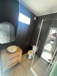 a bathroom with a toilet and a glass shower at Engels apartments - studio luminos in Cluj-Napoca