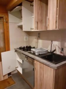 a kitchen with a sink and a stove at CHALETS impasse CHARMAURY et refuge SAMOENS in Samoëns