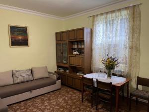 a living room with a couch and a table at Inexpensive house in Vanadzor