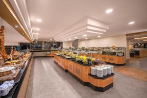 a restaurant with a buffet line with food on display at MEDWORLD Health & Rehabilitation Center Pine Beach Belek in Belek