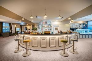 a lobby with a bar with stools around it at MEDWORLD Health & Rehabilitation Center Pine Beach Belek in Belek
