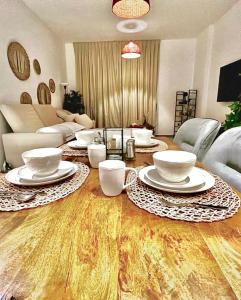 een woonkamer met een tafel met borden erop bij Yas Island canal 1- Formula 1, Entertainment, and Luxury Living! in Abu Dhabi