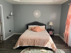 a bedroom with a bed with orange pillows at Locked In in Charlotte