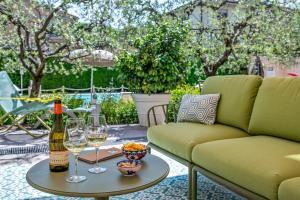 a bottle of wine and two glasses on a table at Hotel San Marco in Lucca