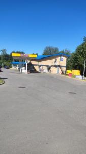 a gas station with a yellow and blue building at Trevena Kretinga in Kretinga