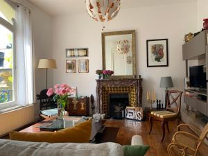 a living room with a couch and a fireplace at Persévérance in Dinard