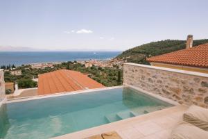 a swimming pool with a view of the ocean at Mani Luxury Suites and Studios in Gytheio with Private Pools in Gythio
