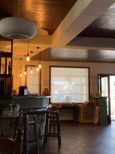 a kitchen with a bar with stools and a window at Hôtel De Porticcio in Porticcio