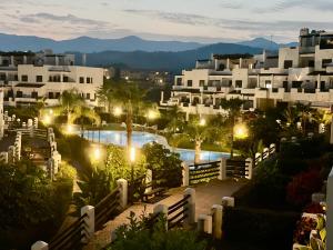 Blick auf ein Resort mit Pool in der Nacht in der Unterkunft Ocean View Apartment Resina Golf Marbella/Estepona in Estepona