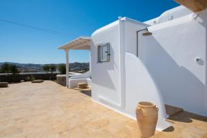 a white house with a terrace with white stairs at Little Villa amid Super Paradise-JackieO' Mykonos in Super Paradise Beach