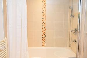 baño con ducha con cortina blanca en 2 Bedroom Chinatown Apartment, en Birmingham 11 fotos más