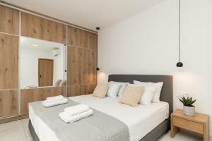 a bedroom with a large white bed and a mirror at Eagle's Nest - Adjoining Villas! in Tsilivi +29 photos