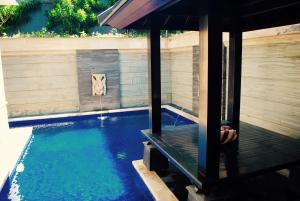 a swimming pool with a dog in the middle of it at Room in Villa - Kori Maharani Villas - One Bedroom Villa with Private Pool 4 in Siyut