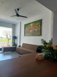 a living room with a couch and a painting on the wall at The Kd Suites & Coffee Shop in Munggu
