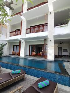 a villa with a swimming pool in a resort at The Kd Suites & Coffee Shop in Munggu