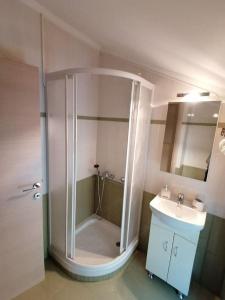 a bathroom with a shower and a sink at Villa ioli breathtaking view & sunset in Agios Nikitas