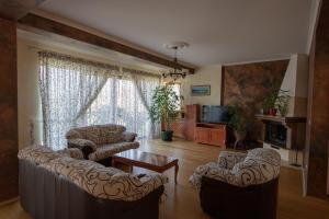 a living room with two couches and a table at Villa Sveta in Petrovac na Moru