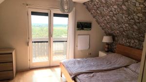 a bedroom with a bed and a large window at Haus Trappiste FOR FAMILIES ONLY NON SMOKING !! AIRCO ! in Donnerskirchen +27 photos