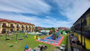 a park with a playground with a play equipment at Willa Kwiatano - Plac zabaw & Jacuzzi & Basen & Sauna - Budynek C in Grzybowo