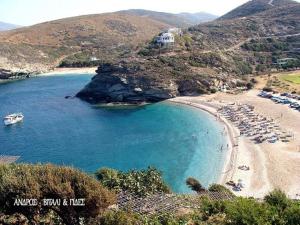 a beach with a bunch of boats in the water at Andros Melissari in Koumárion