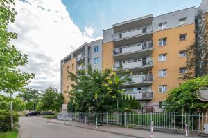 an apartment building with a fence in front of it at Sokratesa 2B by Homeprime in Warsaw