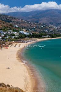 a view of a beach with a town in the background at Andros Melissari in Koumárion