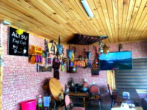 a room with a brick wall with a table and chairs at ACISU CAFE KONAKLAMA in Trabzon