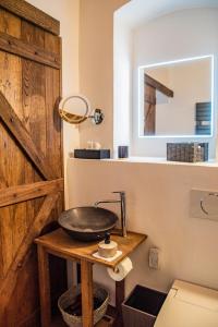 a bathroom with a sink on a wooden table at Na Golfu in Kestřany