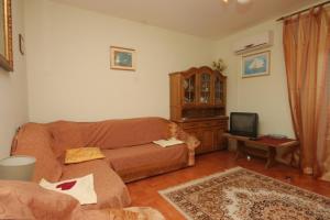 a living room with a couch and a tv at Apartments with a parking space Kraj, Pasman - 8288 in Kraj