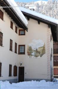 a building with a painting on the side of it at Livigno Chalets in Livigno