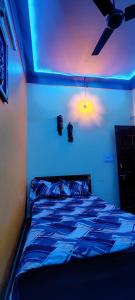 a room with a bed with blue lights on it at Startup House in Dehradun +14 photos