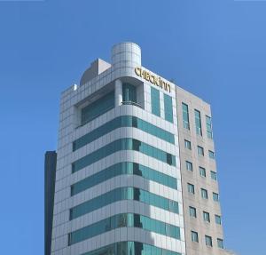 a building with a chevron sign on it at CHECK inn Taipei Nanjing in Taipei