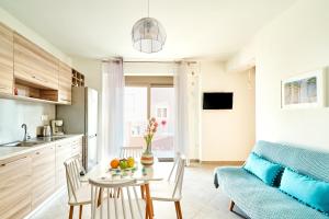 a kitchen and living room with a table and a couch at Lydia's Apartments in Kissamos