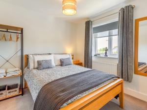 a bedroom with a large bed and a window at Sea View in Rhosneigr