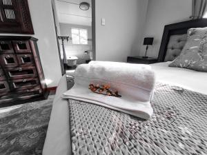 a bedroom with a bed with a towel on it at The Outpost Dullstroom in Dullstroom