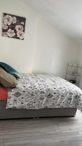 a bedroom with a bed with a floral comforter at Medway Stay in Chatham