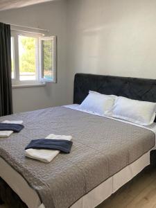 a bedroom with a bed with two towels on it at Seaside holiday house Razanj, Rogoznica - 19159 in Ražanj