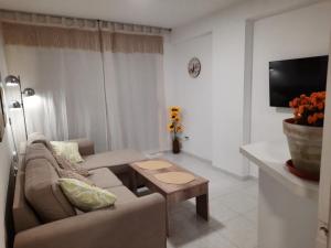a living room with a couch and a table at VERANO AZUL in Benidorm