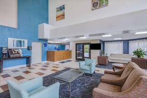 a lobby of a hospital with chairs and a table at Days Inn & Suites by Wyndham Savannah Midtown in Savannah