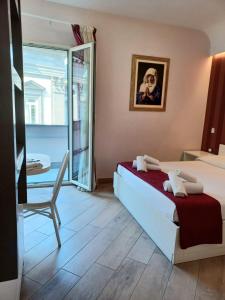 a bedroom with a bed and a chair and a window at B&B Federico Secondo in Naples
