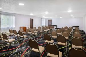 an empty room with chairs and a podium in it at Super 8 by Wyndham Pensacola in Pensacola