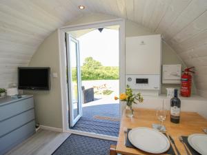 a room with a dining table and a sliding glass door at Cherry Pod in Shrewsbury