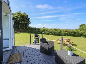 a deck with a grill and a table and chairs at Cherry Pod in Shrewsbury