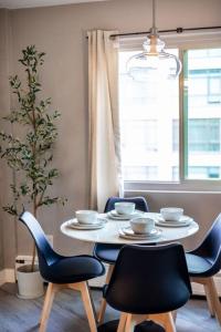 a dining room with a table and chairs and a window at 2BR Downtown Convention Center Near Attractions in Seattle