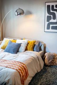 a bed with pillows on it in a room at 2BR Downtown Convention Center Near Attractions in Seattle