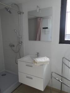 a white bathroom with a sink and a shower at 37 au soleil in Montréal +10 photos