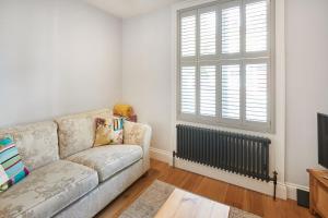 a living room with a couch and a window at Host & Stay - The Old School House in Pickering +10 photos