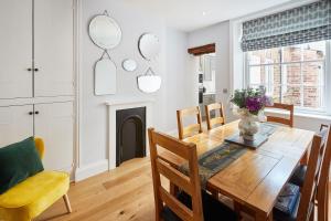 a dining room with a wooden table and chairs at Host & Stay - The Old School House in Pickering