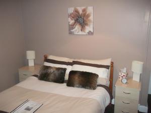 a bedroom with a bed with two night stands and two lamps at Atlantis Hotel in Blackpool
